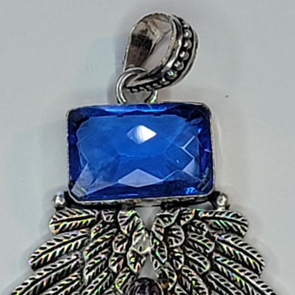 Sterling Silver Pendant with Brown Carved Face, Blue Topaz, and Feather Motif - Picture 9 of 13